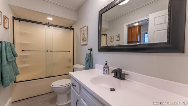 full bathroom featuring shower / bath combination with glass door, toilet, wood finished floors, and vanity