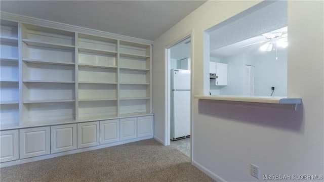 corridor with baseboards and carpet flooring