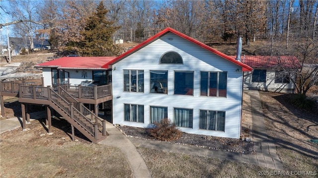 back of house featuring a deck and stairway