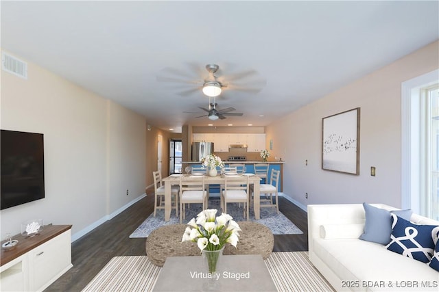 living room featuring ceiling fan, dark wood finished floors, visible vents, and baseboards