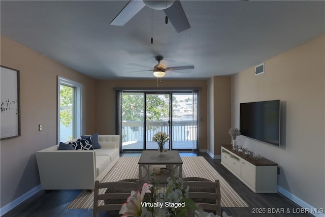 living room featuring dark wood-style floors, visible vents, ceiling fan, and baseboards