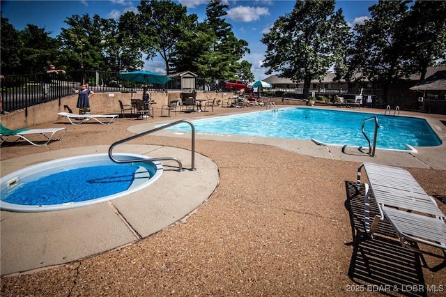 community pool with fence and a patio area