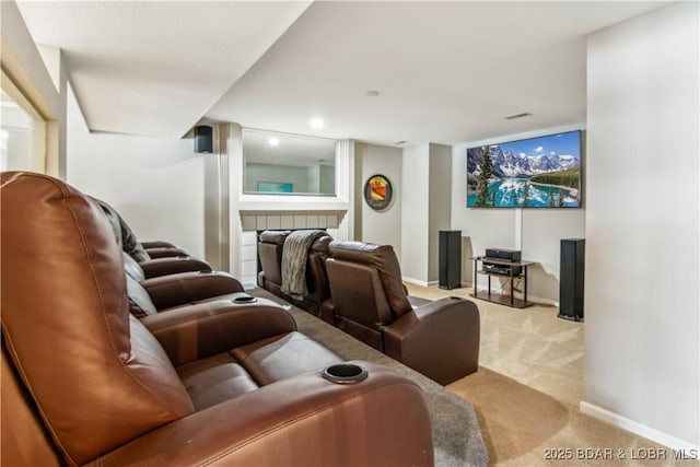 cinema room featuring carpet floors, a fireplace, and baseboards