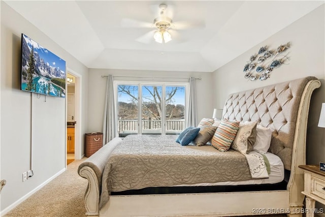 carpeted bedroom with connected bathroom, a ceiling fan, baseboards, access to outside, and a tray ceiling