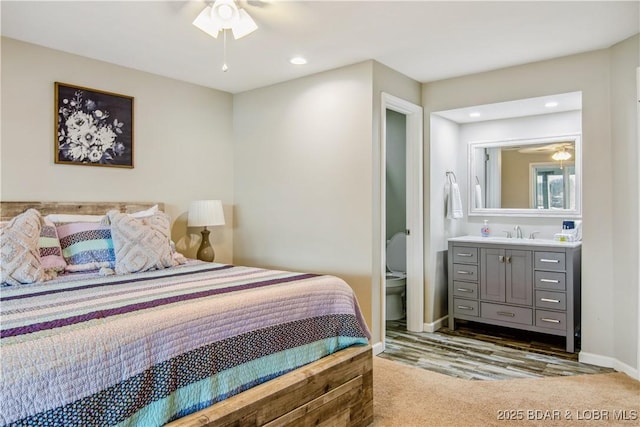 bedroom with recessed lighting, a sink, and baseboards