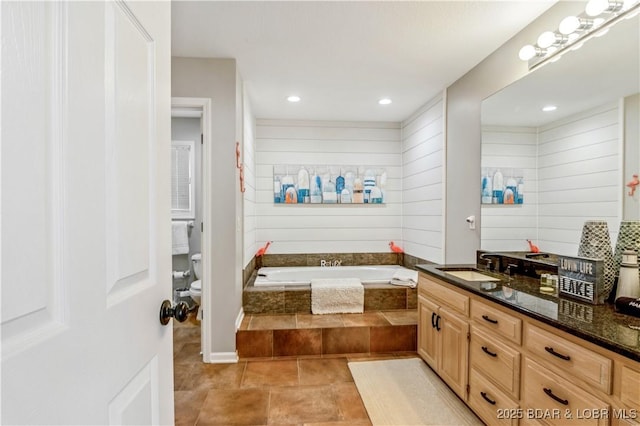 full bathroom with tile patterned flooring, recessed lighting, wood walls, vanity, and a bath