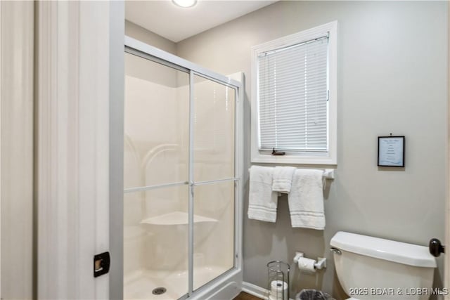 full bathroom with a shower stall and toilet