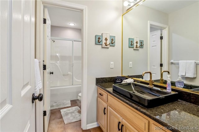 full bathroom with tile patterned flooring, combined bath / shower with glass door, vanity, and toilet