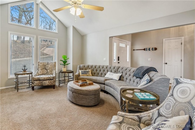 carpeted living room with ceiling fan, high vaulted ceiling, and baseboards