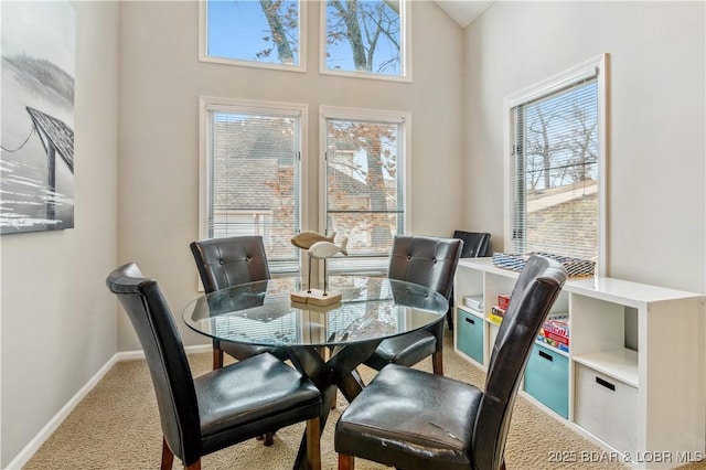 carpeted dining area with baseboards