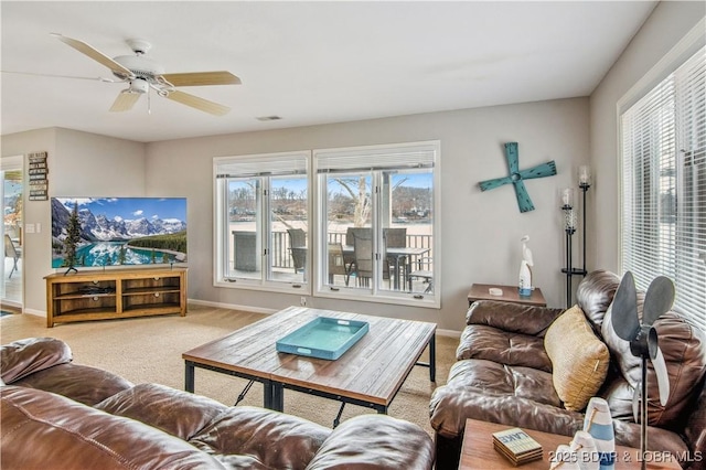 living area with a ceiling fan, carpet flooring, visible vents, and baseboards