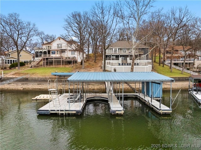 dock area with stairway, a water view, boat lift, and a residential view