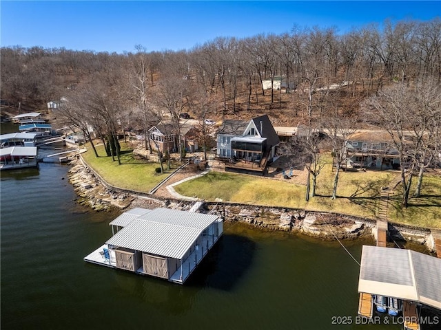 dock area with a water view and a lawn