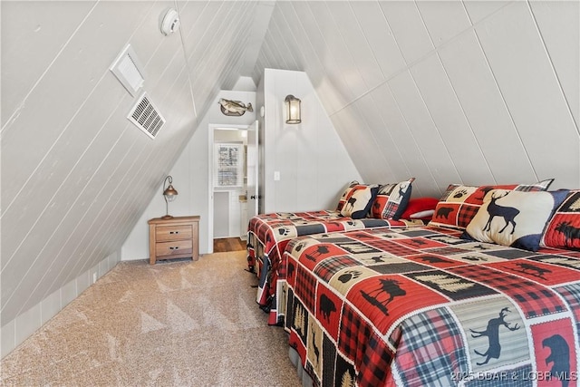 carpeted bedroom with lofted ceiling and visible vents