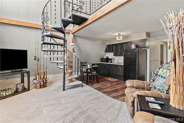 living area with dark wood-style flooring and stairs