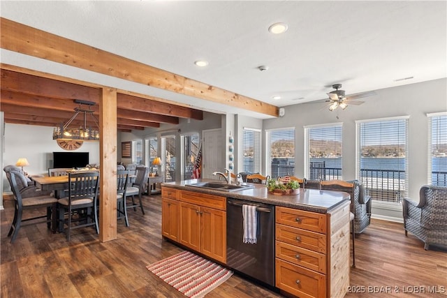 kitchen featuring dark wood-style floors, dark countertops, black dishwasher, and a sink