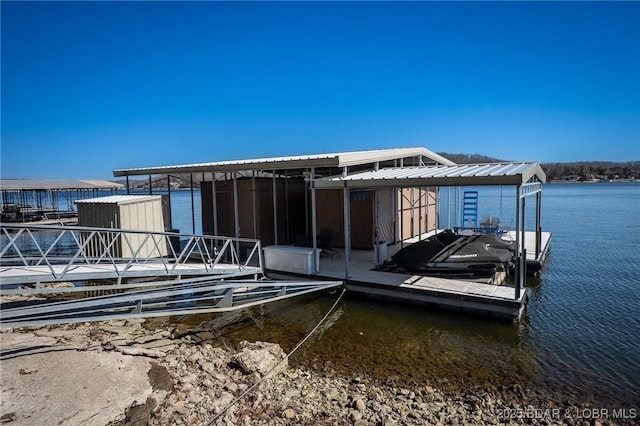 back of house featuring a water view and metal roof