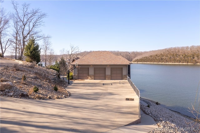 view of front of house with stone siding and a water view