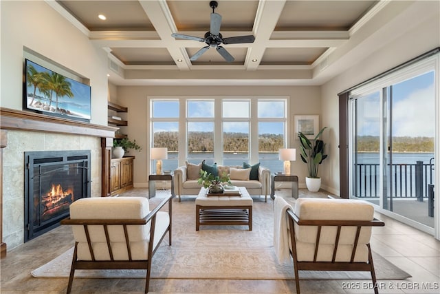 living area featuring baseboards, coffered ceiling, a fireplace, a towering ceiling, and beamed ceiling