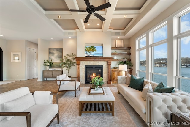 living area featuring beamed ceiling, coffered ceiling, a high ceiling, a fireplace, and baseboards