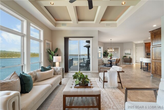 living area featuring visible vents, baseboards, a chandelier, a towering ceiling, and coffered ceiling