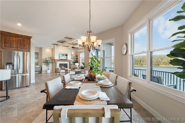 dining area with baseboards, coffered ceiling, recessed lighting, a warm lit fireplace, and beamed ceiling