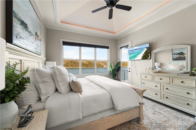 bedroom with a raised ceiling, a ceiling fan, crown molding, and access to outside