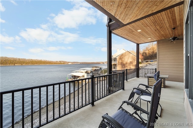 balcony with a ceiling fan and a water view