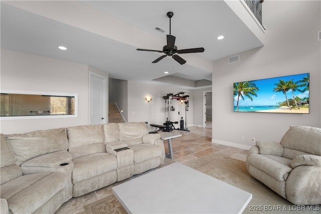 living room with recessed lighting, visible vents, baseboards, and stairs