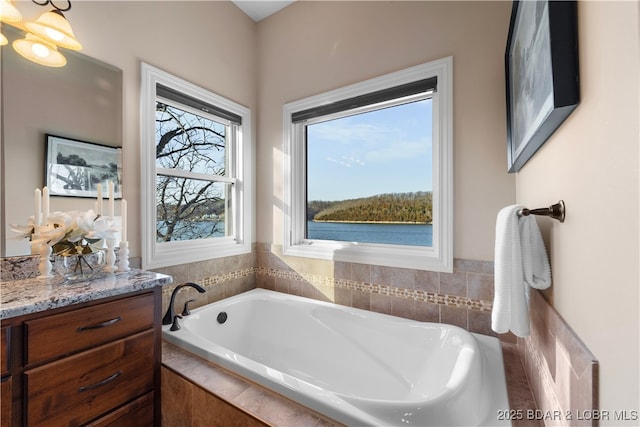 full bath featuring vanity and a bath