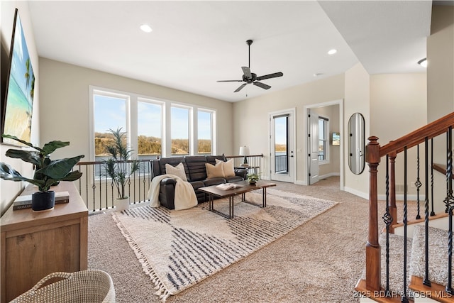 living area featuring recessed lighting, stairway, light carpet, and baseboards