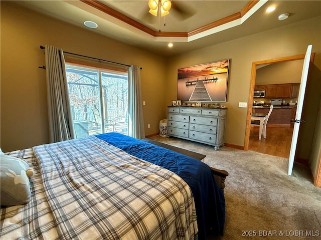 bedroom featuring light carpet, baseboards, access to outside, ornamental molding, and a tray ceiling