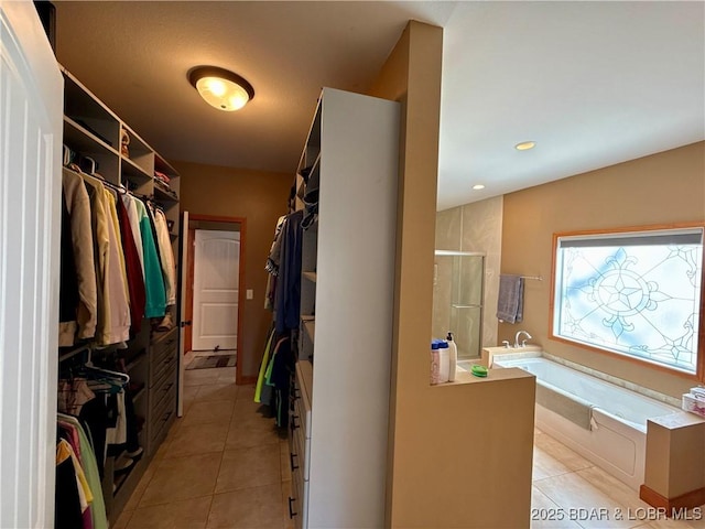 walk in closet with light tile patterned floors