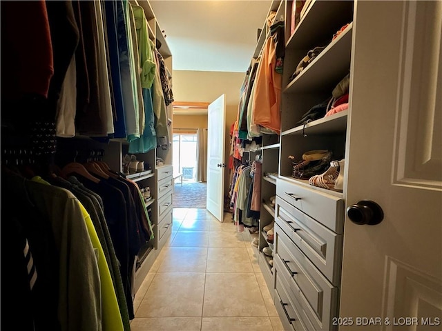 spacious closet with light tile patterned floors