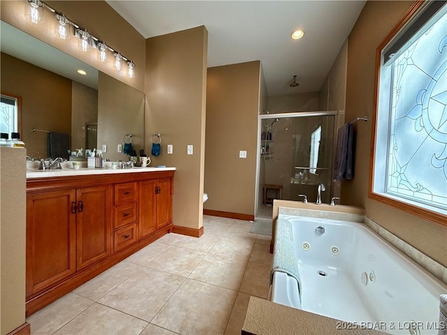 bathroom featuring double vanity, a stall shower, a sink, a tub with jets, and tile patterned floors