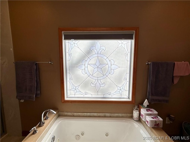 full bathroom with plenty of natural light and a whirlpool tub