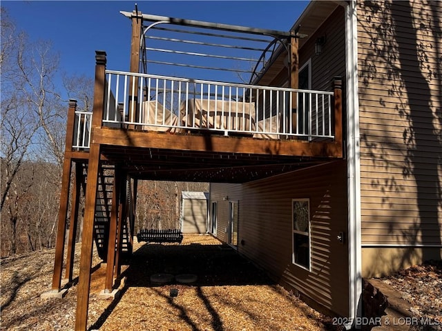 back of house with a carport and a deck