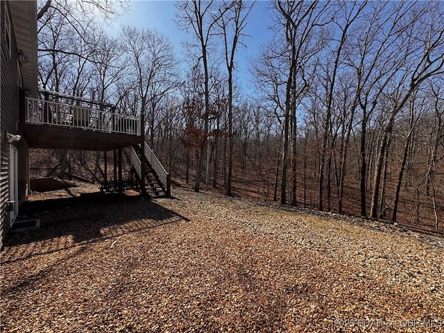 view of yard with stairs and a deck