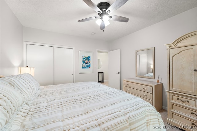 bedroom with a ceiling fan, a closet, a textured ceiling, and light wood finished floors