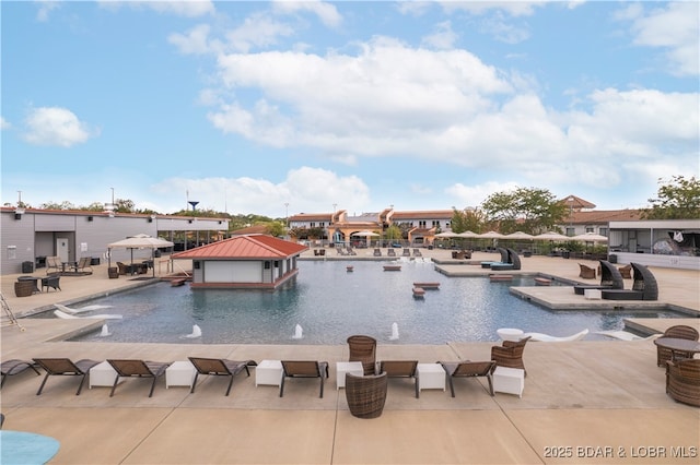 pool with a dock and a patio area