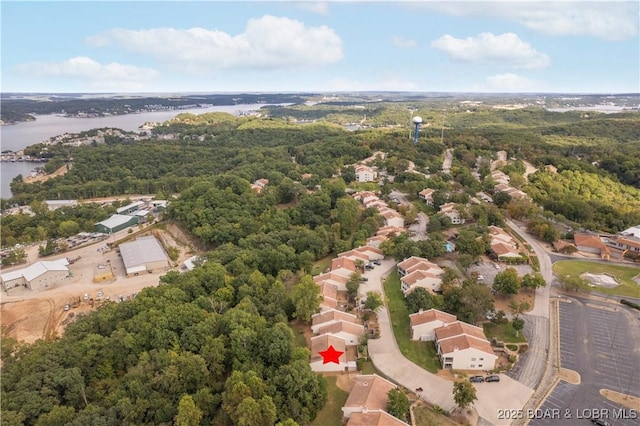 aerial view featuring a water view and a forest view