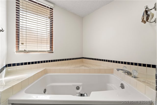 full bath with a textured ceiling and a tub with jets