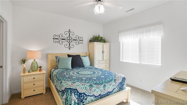 bedroom featuring visible vents, baseboards, a ceiling fan, and carpet flooring