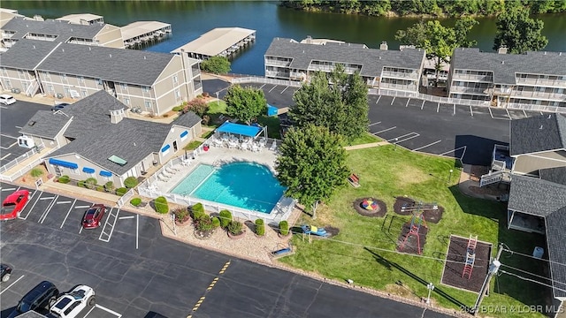 birds eye view of property with a residential view and a water view