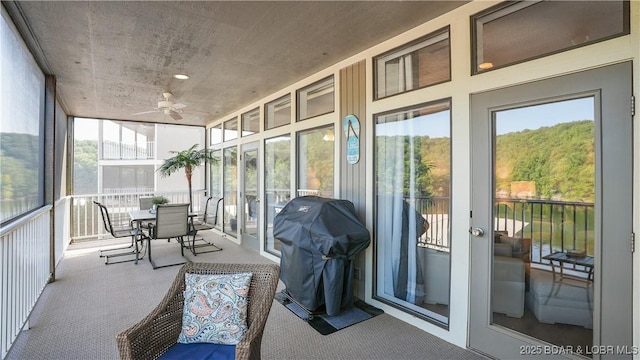 sunroom featuring ceiling fan