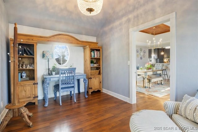 office space with baseboards, wood finished floors, and a chandelier