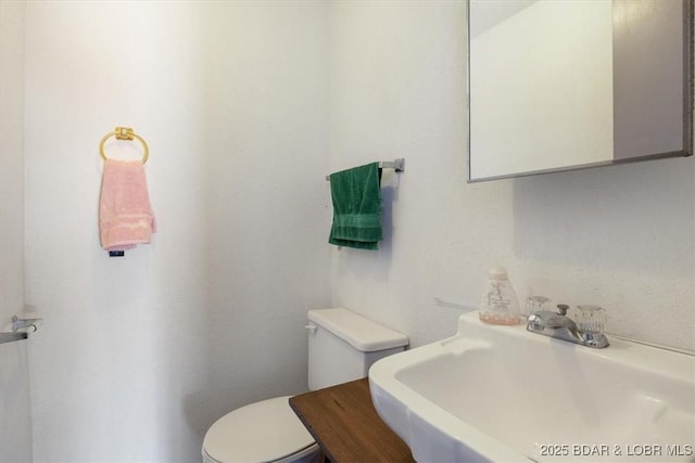 bathroom featuring toilet and a sink