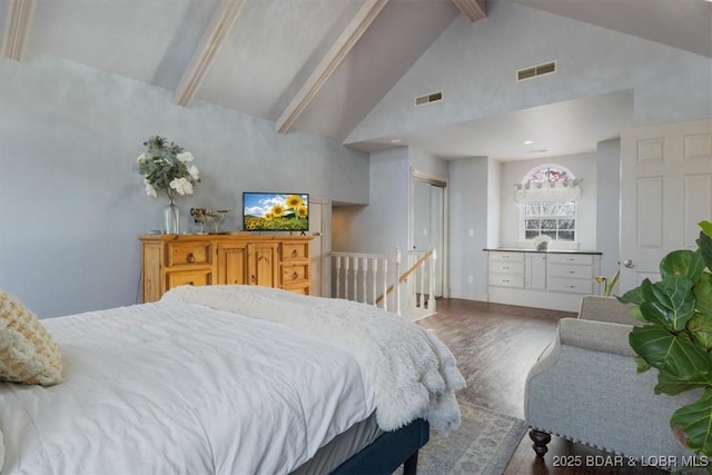 bedroom with beam ceiling, visible vents, high vaulted ceiling, and wood finished floors