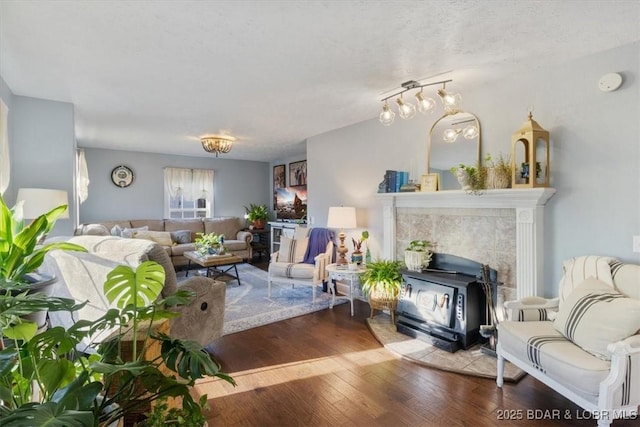 living room with hardwood / wood-style flooring and a wood stove