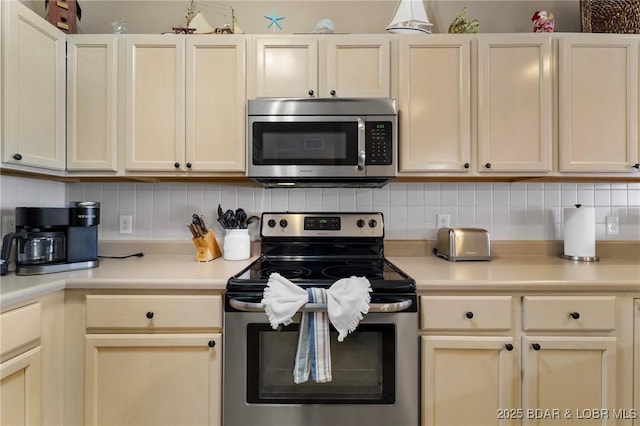 kitchen with decorative backsplash, appliances with stainless steel finishes, and light countertops